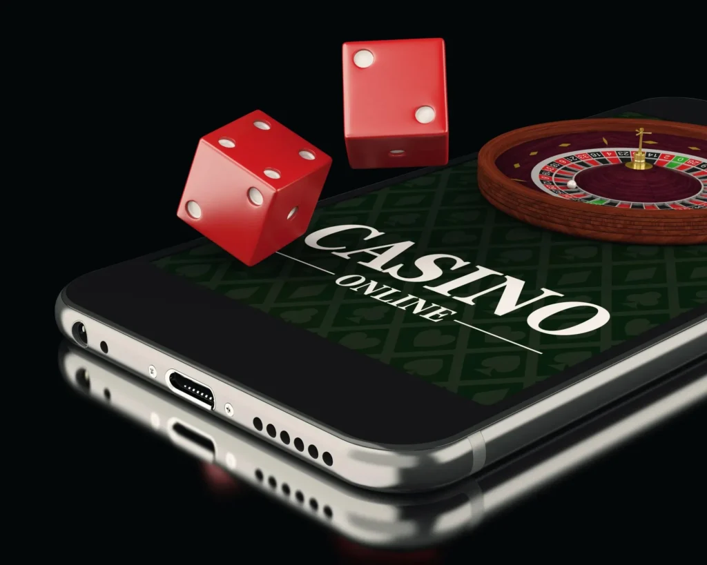 casinoGames A smartphone screen displaying a casino games website, with a roulette wheel and two red dice on top of the phone